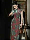 Close-up front view of a model wearing the classic cheongsam, a traditional chinese cheongsam dress with striking red and green floral and phoenix prints. The velvet fabric drape, tailored fit, and subtle details of this timeless qipao traditional dress are highlighted in soft studio lighting.