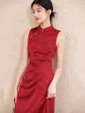 Close-up of traditional red wedding cheongsam with golden tassel frog buttons, sleeveless high-collar bridal cheongsam in deep red satin
