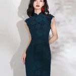 Front view of elegant women's dark green qipao with rose jacquard pattern, cap sleeves, red frog buttons and high slit, model standing against white background.