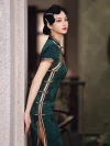 Elegant woman in dark green vintage floral qipao with traditional frog buttons, leaning against a stone pillar, showcasing the side slit and retro silhouette.
