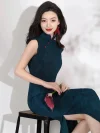 Elegant women's dark green qipao with subtle rose jacquard pattern, cap sleeves and red frog buttons, model sitting with a pink calla lily, high slit traditional Chinese dress.