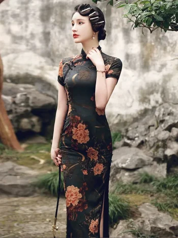 Elegant woman in a stone garden, wearing a high slit peony cheongsam dress with a dark floral print and traditional frog buttons, embodying the timeless charm of Old Shanghai fashion.