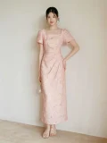 Full-body view of women's summer modified cheongsam, new Chinese style long dress with square neck puff sleeve, waist cinched pleated design in soft pink textured fabric for weddings & summer parties