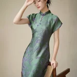 Full view of women's green modified qipao dress, short sleeve cheongsam with purple floral 3D cut flower craft, featuring a traditional mandarin collar and slim fit silhouette for formal occasions