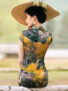 Back view of a women high end yellow mulberry silk cheongsam dress, highlighting the detailed landscape print, tailored fit, and classic mandarin collar design.