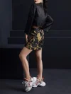 Back view full-body shot of the ink black tiger jacquard A-line short skirt, showcasing the skirt's silhouette from the back and the detailed tiger pattern; high-waisted black short skirt for versatile styling