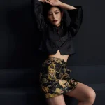 Full-body fashion shot of the ink black tiger jacquard high waist A-line short skirt, paired with a traditional Chinese cropped jacket, showcasing the bold tiger pattern and structured A-line silhouette; stylish black short skirt for modern outfits
