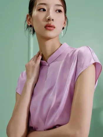 Close-up of a woman wearing a lavender women's modern Chinese mulberry silk cheongsam shirt, highlighting the smooth silk texture and sophisticated stand collar of this refined qipao top.