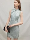 Side profile view of a model holding a black clutch in a light blue modern Chinese sleeveless short cheongsam dress, showcasing the dress’s elegant lines.