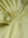 Close-up detail shot of the ruched waist design on a light green women's modern Chinese mulberry silk cheongsam shirt, showcasing the smooth, lustrous texture and refined tailoring of this premium short sleeve qipao top.