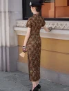 Back view of a women's long checkered cheongsam, an Old Shanghai style qipao dress with a classic geometric checkered print. The model stands outdoors near a historic building, holding a hand fan, showcasing the full back design, high slit, and tailored silhouette, styled with black heels and lace gloves.