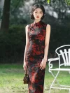 Front view of women's long vintage floral sleeveless high cut qipao (cheongsam) with bold red dragon print on black fabric, model standing outdoors holding a small brown handbag.