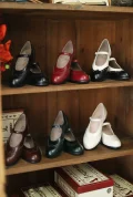 Full color collection of Margarita 1920s Vintage Schoolgirl Style Leather Qipao Mary Jane Shoes, including black, red, white, brown, and green, displayed on a vintage wooden shelf.