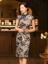 Side view of a woman in a misty blue bamboo brocade cheongsam dress, highlighting the form-fitting silhouette, short sleeves, and intricate geometric-bamboo print against a classic wooden bar backdrop.