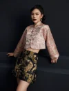 Mid-shot of the misty pink modernized jacquard short qipao top, showcasing the intricate wave jacquard texture, traditional frog button placket, and cropped silhouette; elegant modern qipao top with a subtle pink hue