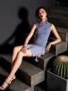 Full view of a woman model sitting on stairs in a form-fitting misty blue cheongsam dress, showcasing the side slit and red trim details of this women's cheongsams qipao.