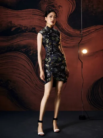 Full-body studio shot of model in form-fitting ink black modern Chinese silk mini cheongsam dress, featuring a high front slit, tailored silhouette, and elegant styling with strappy heels.