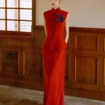 Modern Dark Red Chinese Slim Fit Qipao Dress, woman standing in two-piece sleeveless mandarin collar vest and maxi skirt set with purple flower detail, elegant modern qipao dresses in warm wood-paneled interior, formal traditional chinese outfit