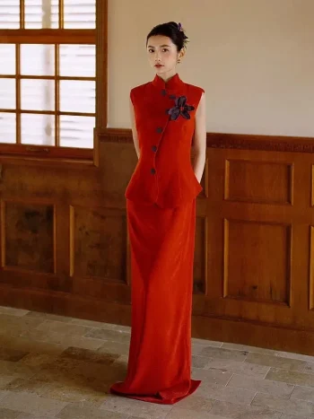 Modern Dark Red Chinese Slim Fit Qipao Dress, woman standing in two-piece sleeveless mandarin collar vest and maxi skirt set with purple flower detail, elegant modern qipao dresses in warm wood-paneled interior, formal traditional chinese outfit