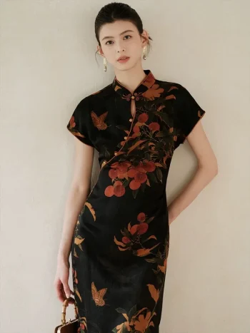 Model leaning against a soft beige wall, wearing a modern high end lightweight short sleeve cheongsam dress. The black mulberry silk qipao features a rich nature inspired print, perfect for elegant everyday wear.