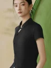 Close-up view of the mandarin collar and traditional frog button on a black modern qipao top, highlighting the elegant keyhole neckline and sleek fabric of this qipao inspired top.