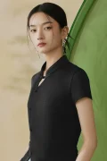 Close-up view of the mandarin collar and traditional frog button on a black modern qipao top, highlighting the elegant keyhole neckline and sleek fabric of this qipao inspired top.