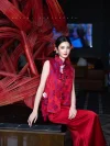 Modern Red Silk Qipao Set - Woman in two-piece qipao set with floral embroidered sleeveless brocade vest and red satin pants, sitting beside a red bamboo art installation in a luxury hotel lobby, elegant modern red qipao for weddings and formal events