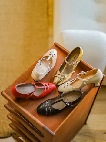 Multi color collection of vintage genuine leather T strap high heel qipao sandals, featuring red cream gold black and beige options, displayed on a warm wooden table, catering to various retro and cheongsam styling needs