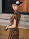 Back-side view of a women's Old Shanghai checkered cheongsam, a long qipao dress with a vintage geometric checkered pattern. The model poses near a historic building, showcasing the tailored fit, short sleeves, and high slit from the side, styled with period accessories including a net hat and drop earrings.