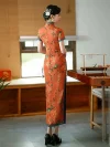 Back view of Old Shanghai style cheongsam (qipao) in tangerine red with peony print and blue trim, full-length traditional Chinese dress on model.