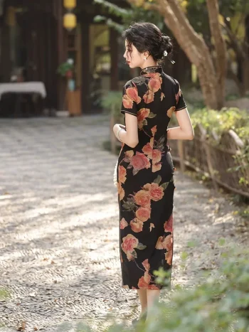 Back view of women's Old Shanghai peony pattern short sleeve cheongsam (qipao) with black base and vintage rose print, model walking outdoors, showing the neat tailoring and back design of the traditional qipao.