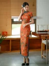 Elegant Old Shanghai qipao (cheongsam) in vibrant tangerine red with peony pattern and blue piping, full-length traditional Chinese dress, model in side pose.