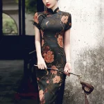 Portrait of a woman leaning against a weathered wall in a high slit cheongsam dress, adorned with a luxurious peony floral print in authentic Old Shanghai vintage style.