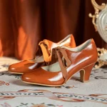 Pair of vintage style genuine leather qipao shoes, 1920s ribbon mary jane heels in rich brown, showcasing the classic cutout design and ribbon bow, ideal for pairing with cheongsam, lolita, and period-style dresses