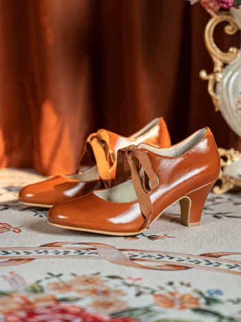 Pair of vintage style genuine leather qipao shoes, 1920s ribbon mary jane heels in rich brown, showcasing the classic cutout design and ribbon bow, ideal for pairing with cheongsam, lolita, and period-style dresses