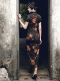 Back view of a woman walking through a traditional doorway in a high slit cheongsam with a rich peony floral print, showcasing the elegant silhouette and Old Shanghai vintage aesthetic.