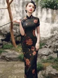 Woman holding a traditional pipe in a stone garden, wearing a high slit cheongsam featuring a rich peony pattern in classic Old Shanghai vintage style, perfect for formal events and cultural occasions.