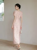 Back view of women's summer modified cheongsam, new Chinese style long dress with square neck puff short sleeve, waist cinched pleated design in soft pink textured fabric for summer occasions