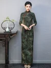 Full-length front view of a plus-size long Momo qipao with 3/4 sleeves, featuring vintage floral and bamboo print in rich green tone.
