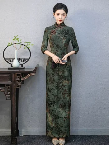 Full-length front view of a plus-size long Momo qipao with 3/4 sleeves, featuring vintage floral and bamboo print in rich green tone.