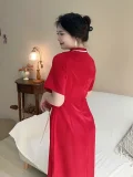 Back view of a plus size red satin qipao dress, elegant chinese red qipao with form-fitting silhouette and high side slit, showing the clean back design in a cozy home interior.