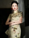 Woman in a 19 momme mulberry silk printed midi cheongsam dress, standing with arms crossed and holding a pearl handbag in a dim vintage interior.