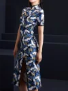 Profile view of a woman standing in a blue crane print midi cheongsam dress, showcasing the high side slit, tailored fit, and intricate crane and floral print of this modern blue cheongsam.