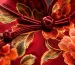 Close-up of a traditional red embroidered silk qipao with handcrafted frog buttons, highlighting delicate craftsmanship that requires checking care labels before cleaning to avoid damage.