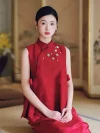 2 Piece Red Chinese Cheongsam Dress - Woman in elegant two-piece cheongsam set with sleeveless mandarin collar vest and matching skirt, sitting in a traditional Chinese room with ink painting screen backdrop, modern red cheongsam for formal events.