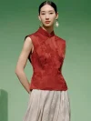 Model wearing a red cheongsam top modern style, a women's red chinese slim fit jacquard cheongsam top with mandarin collar, styled with statement gold earrings in a minimalist studio.