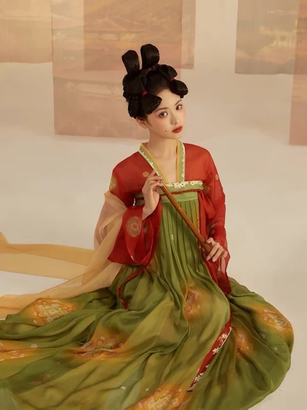 Tang-style chest-high ruqun hanfu in vibrant red and green gradient, worn by a woman with elaborate ancient Chinese hair buns, holding a bamboo flute in a soft vintage studio background.