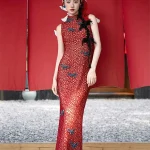 Red Lace Chinese Slim Fit Cheongsam Dress, full body shot of woman in form-fitting red lace cheongsam with blue frog buttons standing in front of red curtains, elegant sleeveless qipao for traditional events