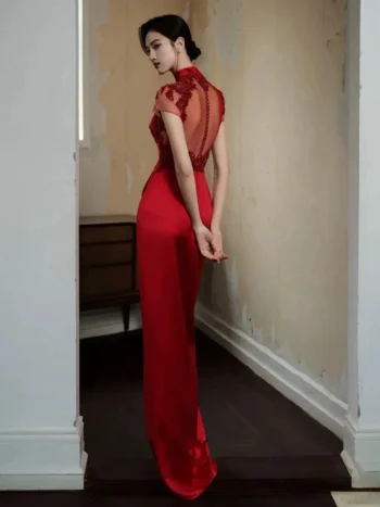 Back view of a red floral embroidery wedding qipao dress, showcasing the sheer lace embroidered back panel and smooth satin fabric of this elegant red qipao dress.
