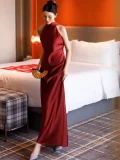 Front view of a red long qipao dress, a sleeveless Chinese wedding qipao dress made of lustrous satin, perfect for bridal photoshoots and wedding ceremonies.